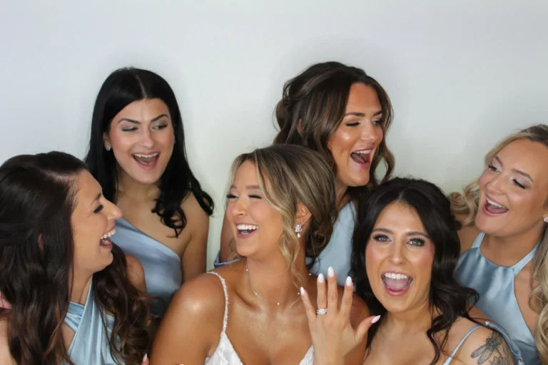 Bridesmaids laughing together in the photo booth